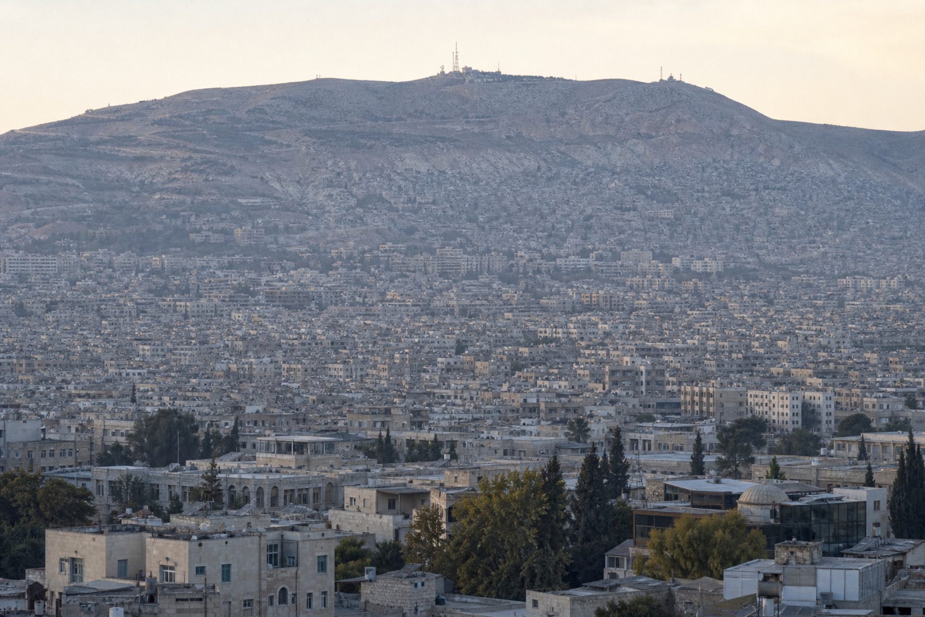Damascus seen from an elevation, with Mount Qasioun behind the city